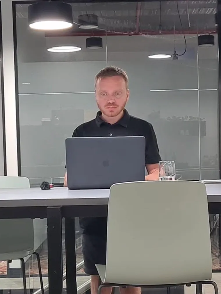 Pavel working at a laptop in a meeting room